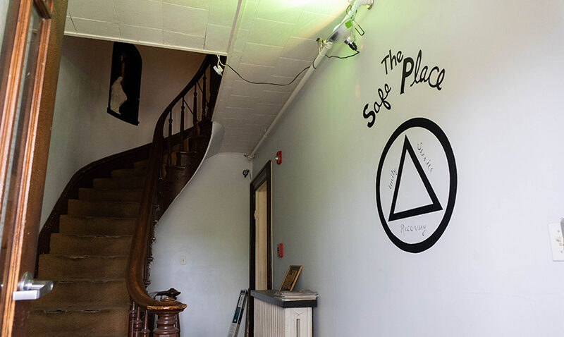 The Safe Place wall sign and stairs leading up in a house